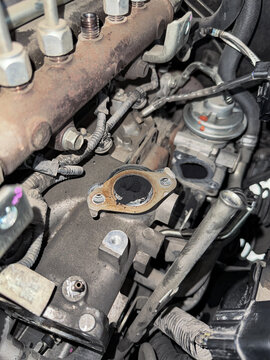 EGR valve cleaning with carbon buildup inside engine component during maintenance