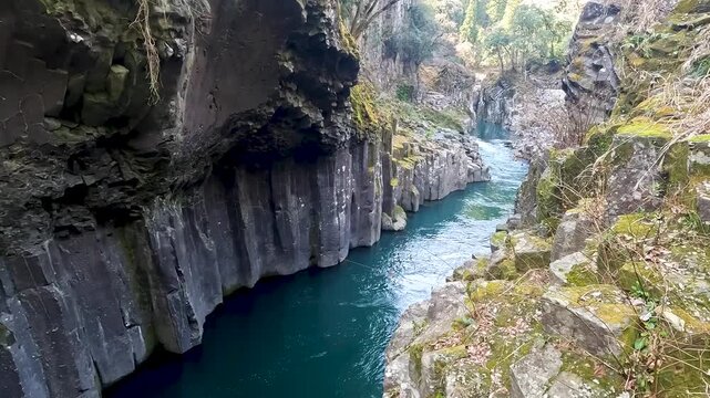 Landscape Takachiho Gorge is River canyon with waterfalls over sheer basalt cliffs viewable from rented boats and a paved path in Takachiho Miyazaki Kyushu Japan - Footage Clip Travel Nature
