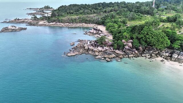 Aerial Drone View of Turun Aban Beach Bangka Featuring Granite Coast Crystal Clear Turquoise Waters Tropical Forest and Hidden Sandy Paradise