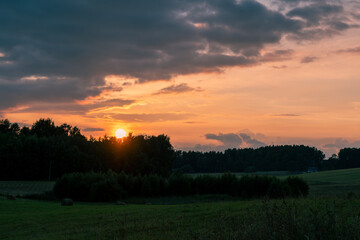 Obraz premium Colorful Summer Sunset Clouds Over the Meadows of Latgale, Latvia