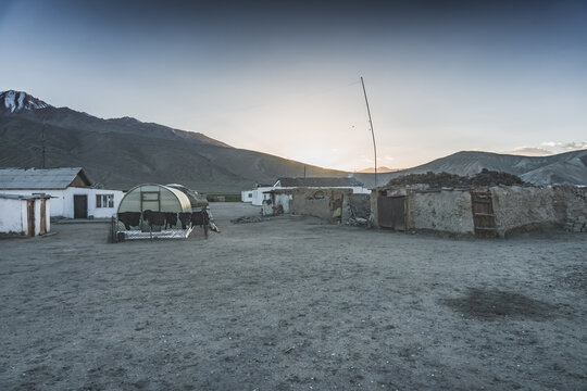 The high-mountain village of Bulunkul in the Tien Shan Mountains in the Pamirs of Tajikistan one-story houses of local residents in the evening against the backdrop of mountain ranges