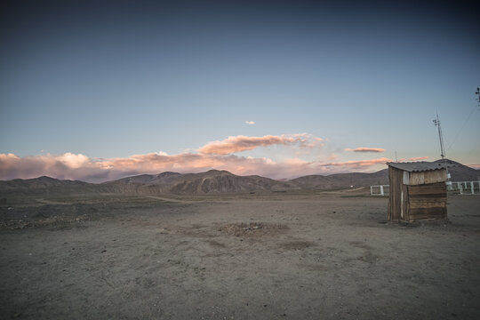 The high-mountain village of Bulunkul in the Tien Shan Mountains in the Pamirs of Tajikistan one-story houses of local residents in the evening against the backdrop of mountain ranges