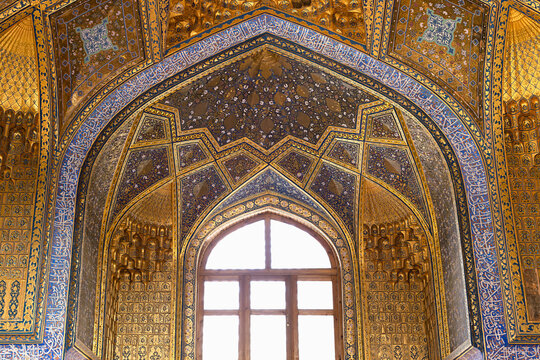 Ornate gilded interior of Ak Saray Mausoleum in Samarkand featuring intricate tilework and muqarnas vaulting. Richly decorated Islamic architecture ideal for travel publications, cultural heritage.