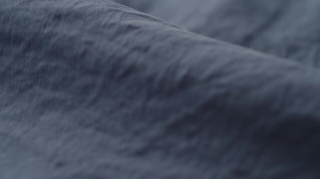 Slow motion man hand checking blue linen shirt cloth