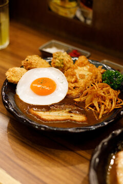 Japanese curry rice dish with thick and spiced sauce pairing with variety of meat.