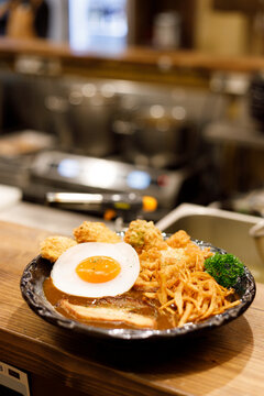 Japanese curry rice dish with thick and spiced sauce pairing with variety of meat.
