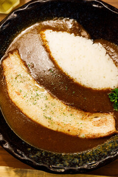 Japanese curry rice dish with thick and spiced sauce pairing with variety of meat.