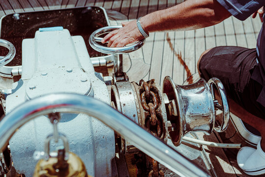 man opening windlass, male hand, walve, sailor working