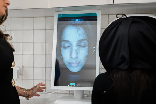 Aesthetics practitioner discussing skin analysis results during client consultation