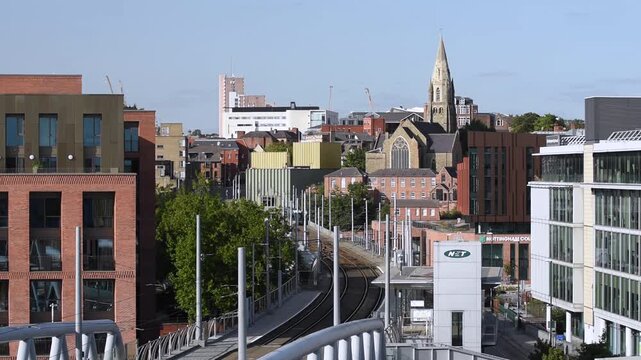 Overlooking a Nottingham tram passing Nottingham Railway Station with the historic Lace Market Neighborhood in the background, near Old Market Square in Nottingham, England.