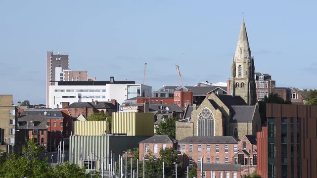 Overlooking a Nottingham tram passing Nottingham Railway Station with the historic Lace Market Neighborhood in the background, near Old Market Square in Nottingham, England.