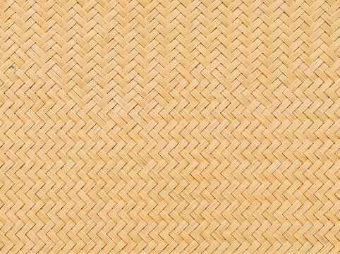 Close-up of natural bamboo woven texture, traditional herringbone basketry pattern background
