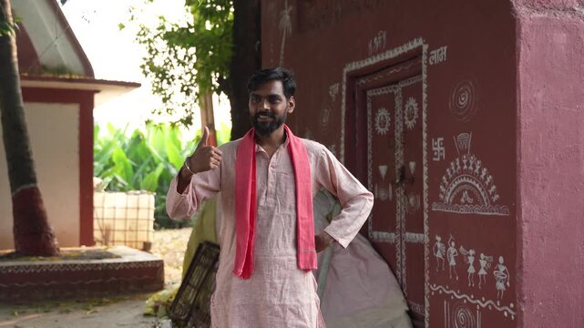 Young indian farmer showing thumps up at home 