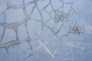 Weathered blue concrete surface featuring cracked paint and distressed texture, ideal as a rustic abstract background for design projects. © Sije