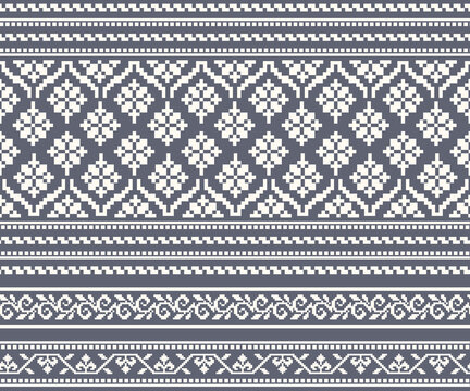 A seamless horizontal pattern featuring various floral and decorative motifs in white tones against a gray geometric background; designed for fabrics, clothing, backgrounds, and decoration.
