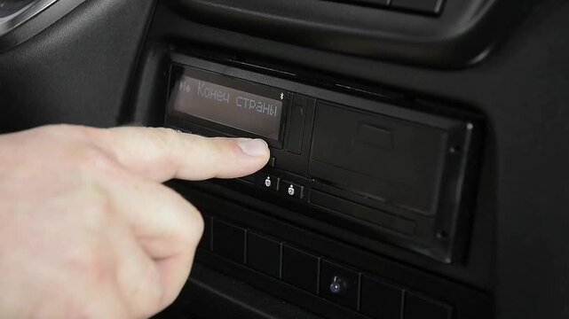 Truck driver operating tachograph to eject chip card