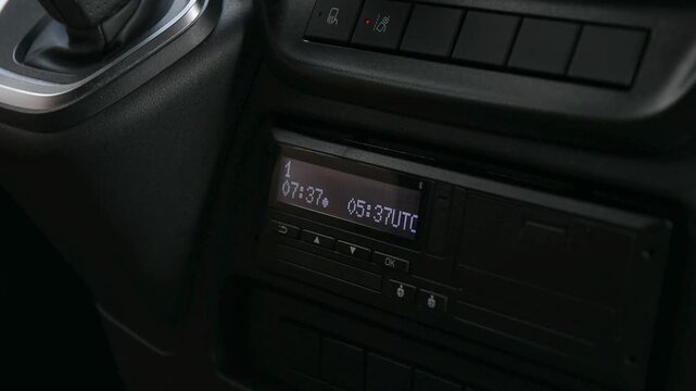 Driver inserting driver smart chip card into tachograph