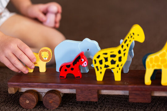 Child playing with animals on flatbed truck for imaginative play