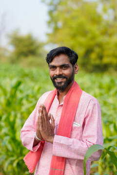 Indian farmer doing namaste or welcome gesture at agriculture field