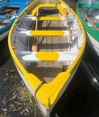 Colourful rowing boats moored on a boating lake. © Philip