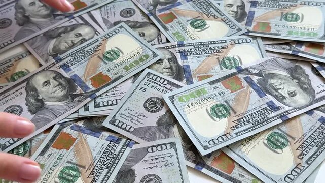 dollars sort, count, spread and display a stack of one hundred dollar bills on a clean white background. A versatile finance concept for savings, wealth, investment, budgeting and cash transactions.