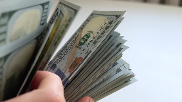 dollars sort, count, spread and display a stack of one hundred dollar bills on a clean white background. A versatile finance concept for savings, wealth, investment, budgeting and cash transactions.