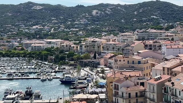 Calvi, Corsica panoramic view of harbor of city with port and houses at sunny day.
