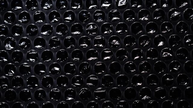 Glossy Plastic Bubble Wrap Macro on Dark Background