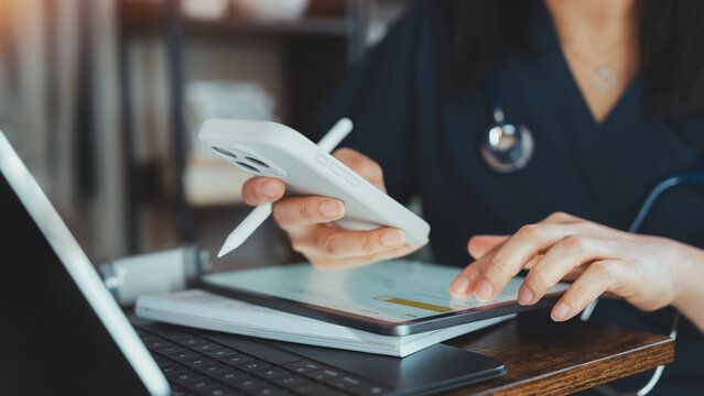 Healthcare Professional Using Smartphone, Tablet And Laptop For Medical Data Management, Telemedicine And Patient Records. Digital Health Technology Supporting Clinical Communication And Workflow
