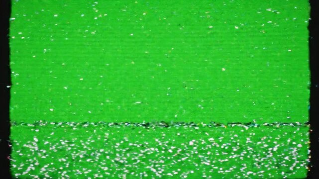Retro VHS glitch effect with analog static noise and tracking errors moving across a bright green screen background for video editing