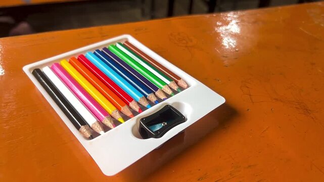 Set of Twelve Multi-Colored Pencils in a White Plastic Tray with a Sharpener