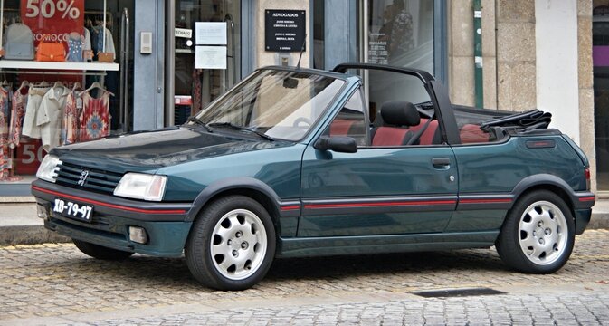 Peugeot 205 CTI convertible parked on European cobblestone street