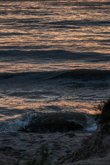 Fototapeta premium Waves in the Baltic Sea at sunset in summer