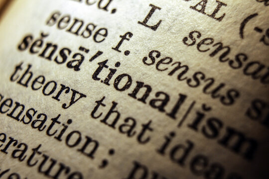 Word sensationalism on dictionary page, macro close up