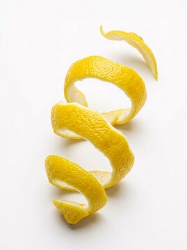 Fresh Spiral Lemon Peel Rind Twist Isolated on a Clean White Studio Background