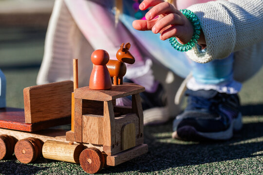 flatbed semi trailer truck toy and child playing with wooden person and dog