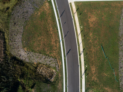 Aerial view of new road in suburb under development
