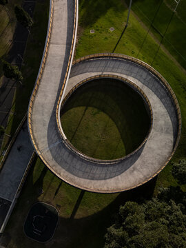 Large spiral bridge aerial view carrying pedestrians, cyclists and joggers. Photo is in vertical format