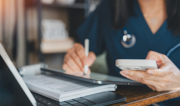 Healthcare Professional Using Tablet Stylus And Smartphone For Medical Data Entry, Telemedicine And Patient Records. Digital Health Technology Supporting Clinical Documentation And Mobile Workflow