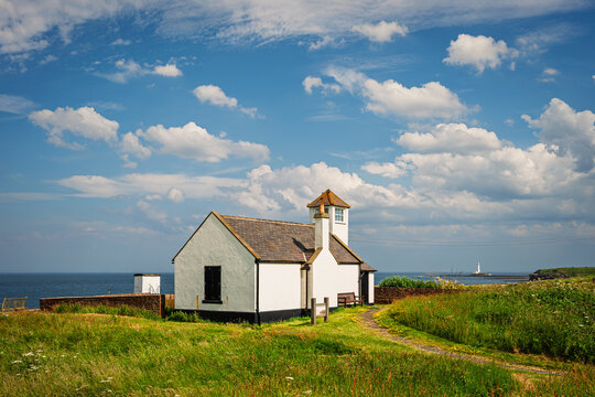 The Watch Tower Museum at Seaton Sluice, a village on the Northumberland coastline, with a rugged shore at Collywell Bay