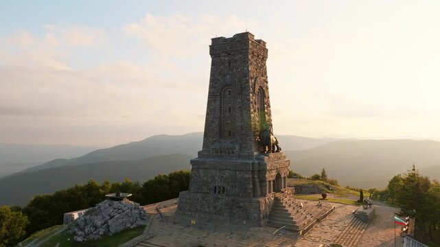 Shipka monument Bulgaria aerial view drone shot sunset, Liberty Monument Stara Planina mountain, Bulgarian historic landmark memorial stone tower golden hour travel destination