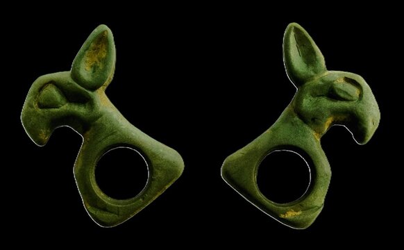 Ancient Scythian bronze horse harness forehead plaques depicting saiga antelope head, animal style artifacts isolated on black background.