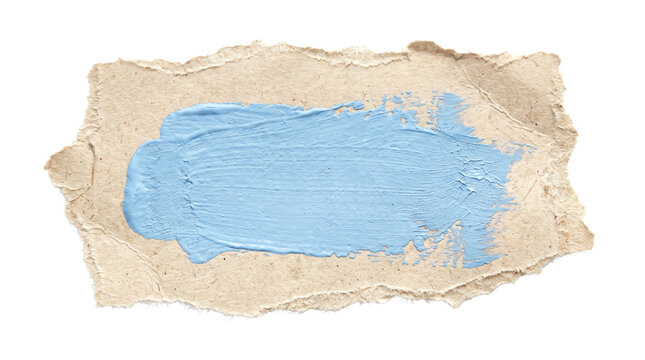 Torn brown cardboard scrap with light blue paint stroke, textured paper fragment with acrylic brush mark, recycled craft paper banner for creative design