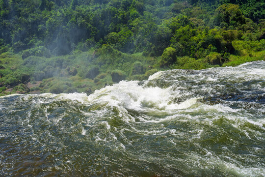 Aerial view of a powerful waterfall edge in the lush green rainforest of Brazil