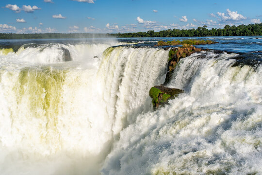 Powerful waterfall cascading over rocky cliffs in the lush tropical rainforest of Brazil