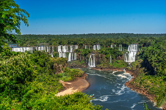 Panoramic view of a large waterfall in the tropical rainforest of Brazil with a river and lush green vegetation
