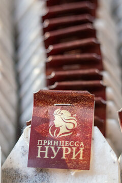 Tea bag tag with princess portrait and russian text on background of many tea packets