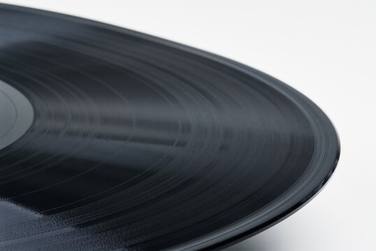 Macro view of a vintage vinyl record showing detailed grooves and textured surface, evoking nostalgia, analog sound and tactile listening experience for music lovers, DJs and collectors.