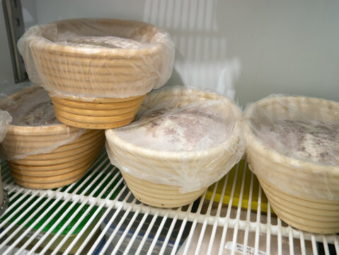 Bread Dough Proofing in Banneton Baskets Inside Refrigerator, Bakery Fermentation Process