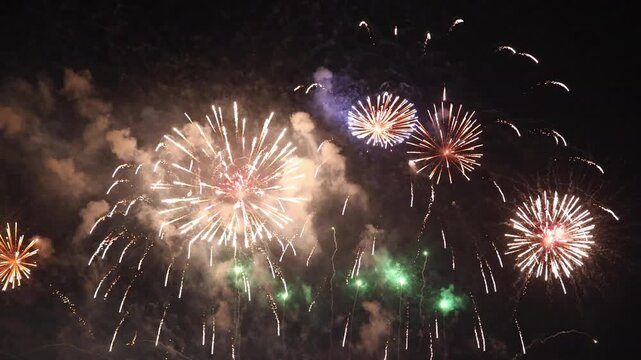 Amazing real beautiful colorful fireworks background on celebration night event for happy new year party or independence day, Abstract Multi color golden firework in the night sky